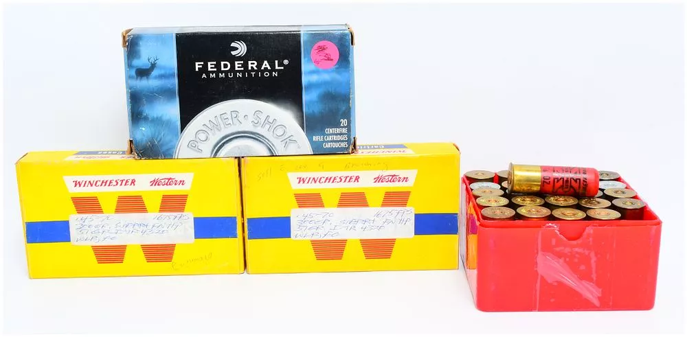 A Collection of 63 Rounds of Ammunition, 20 Empty .45-70 Brass Casings, and Three Vintage Ammunition Boxes