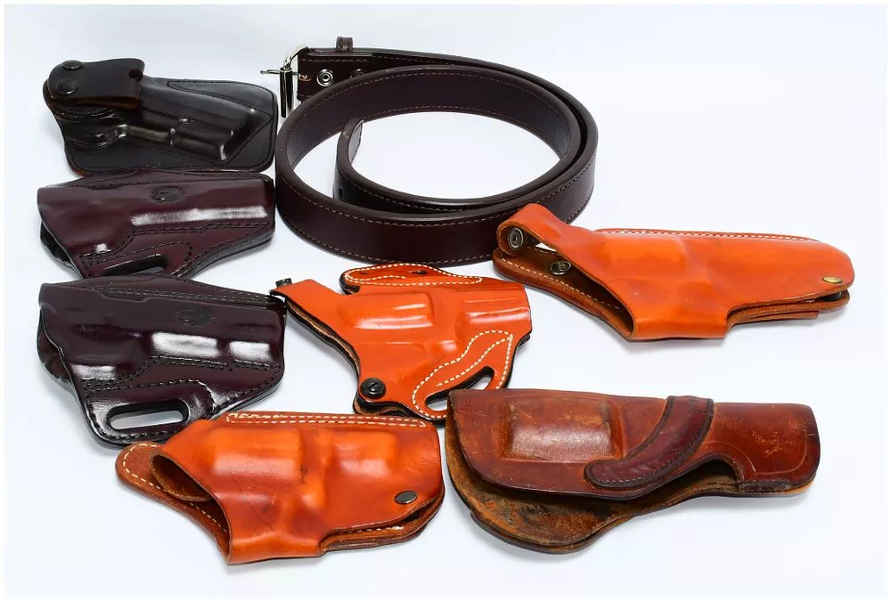 A Collection of Leather Firearm Holsters and a Belt