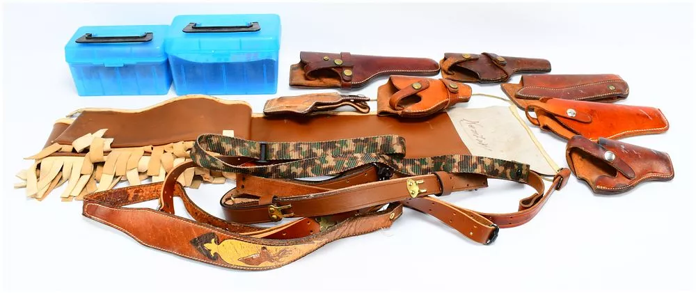 A Collection of Leather Holsters, Belts, and Firearm Accessories