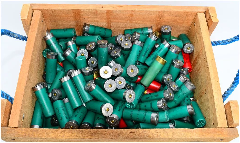 A Collection of Remington Gun Club and Federal 12 Gauge Shotgun Hulls in a Wooden Crate