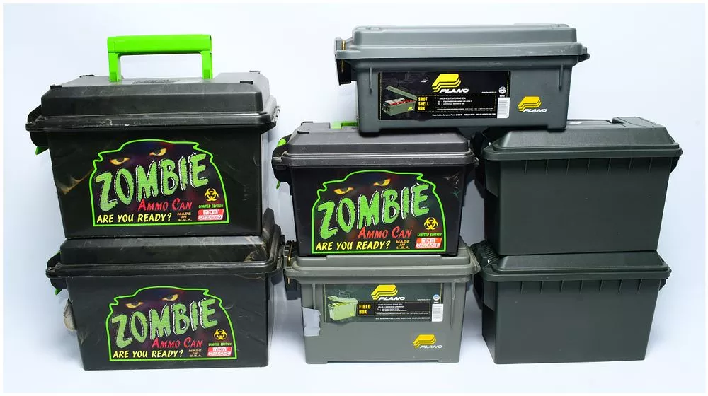 A Collection of Seven Plano and MTM Plastic Storage Containers, including 'Zombie Ammo Cans,' Shot Shell Boxes, and Field Boxes