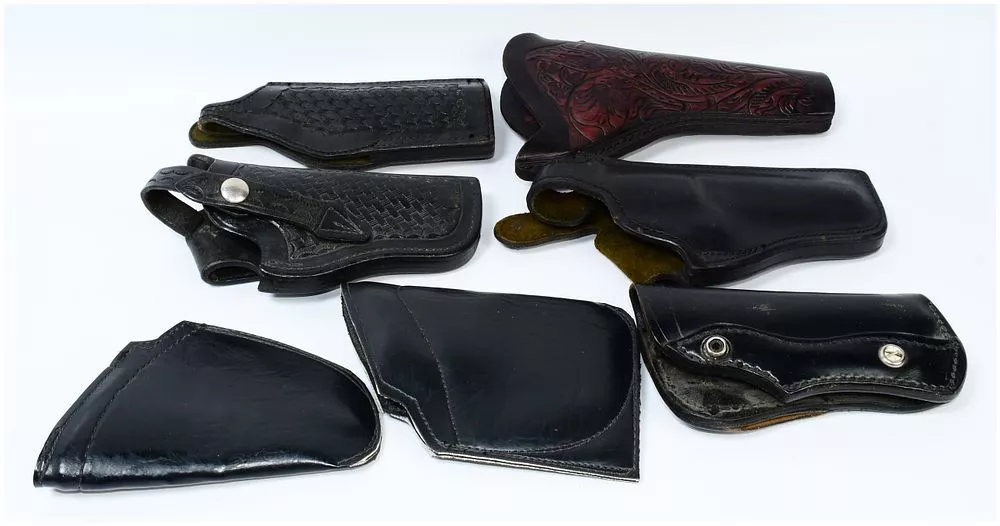 A Collection of Vintage Leather Police and Military Revolver Holsters, including Bucheimer and USAF Examples