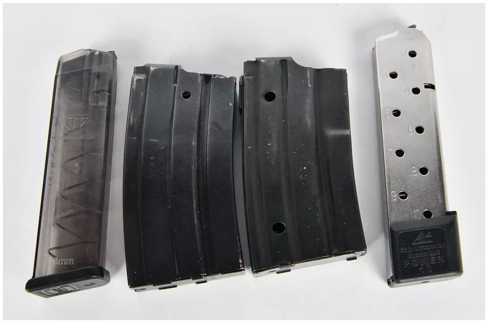 A Group of Four Assorted Firearm Magazines, including Glock 19, AR-15/M16, and Chip McCormick .45 ACP