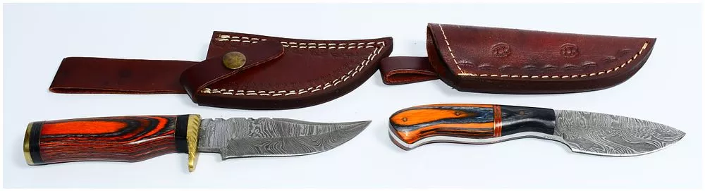 A Pair of Modern Handmade Damascus Steel Fixed-Blade Knives with Layered Wood Handles and Leather Sheaths