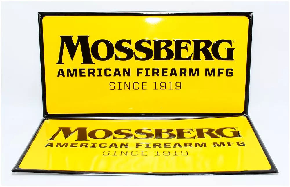 A Pair of Mossberg Advertising Signs with Four Boxes of Vintage Shotgun Shells