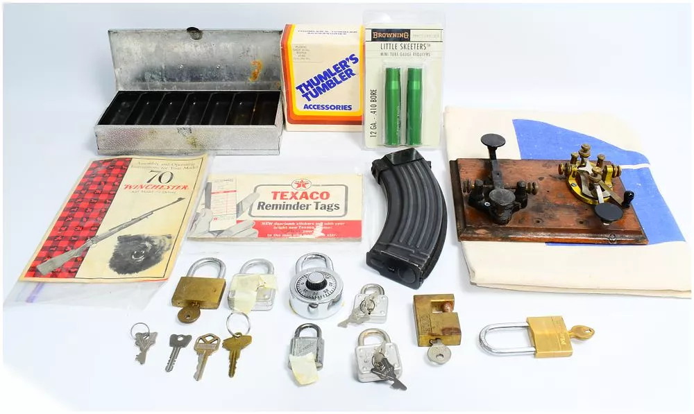 Vintage Morse Code Telegraph Key and Receiver Set with a Collection of Firearm Accessories, Security Locks, and Promotional Items
